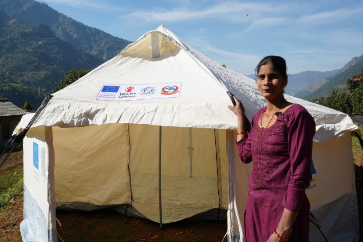 Sita standing next to the shelter tent.