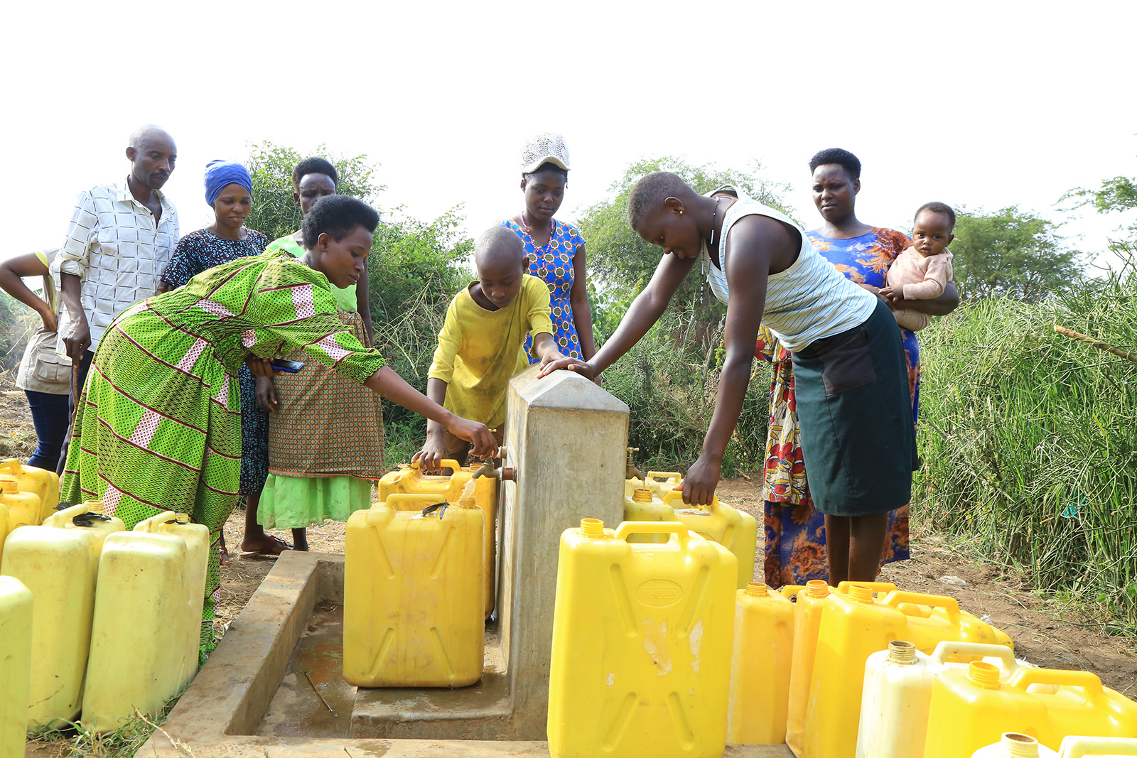 People filling up jerry cans with water at a water tap