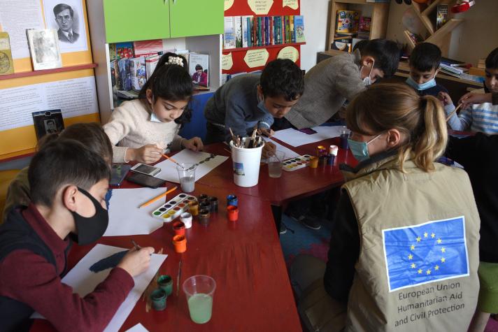 Children drawing and painting in an art session