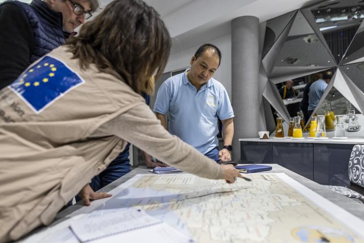 Aid workers pointing at a map