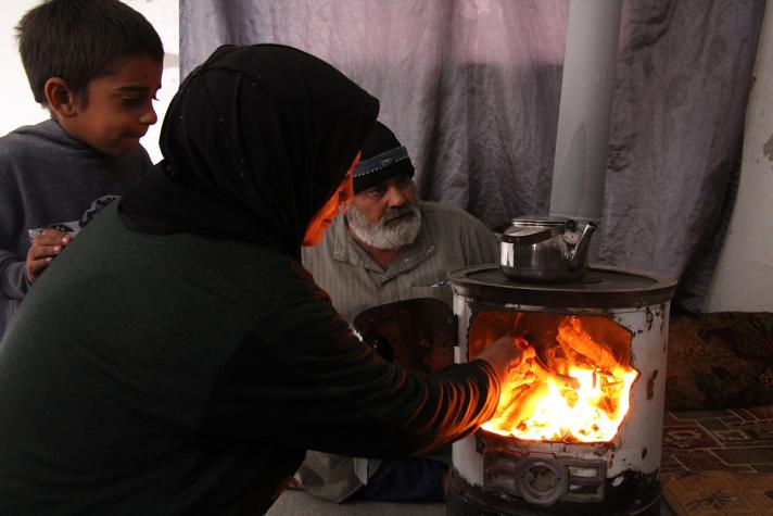 People in front of a stove