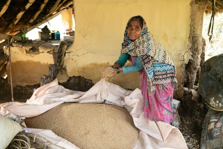 Woman taking grain out of a bag