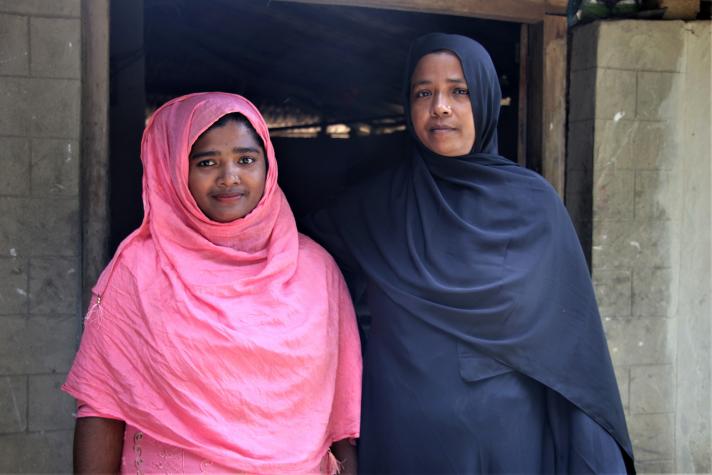 Sumaiya and her mother in front of their house