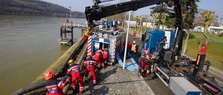 A team pumping water along a canal
