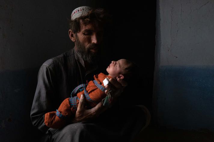 Muhammad Ajman holds his newborn daughter Fatima.