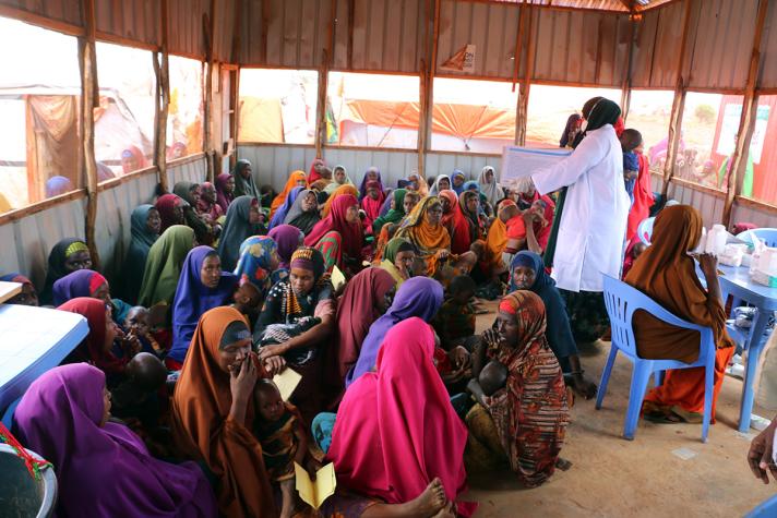 Woman being briefed by health workers