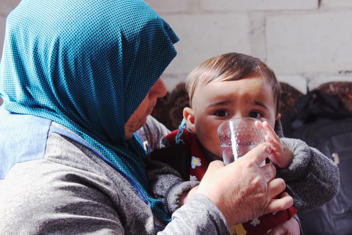 Abu Reza’s oldest daughter is helping her child with a glass of water. 