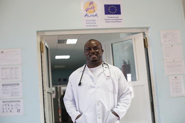 Doctor standing in front of open doors in a health ward