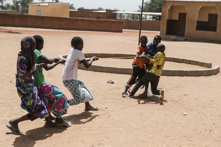 2 groups of children playing tug of war