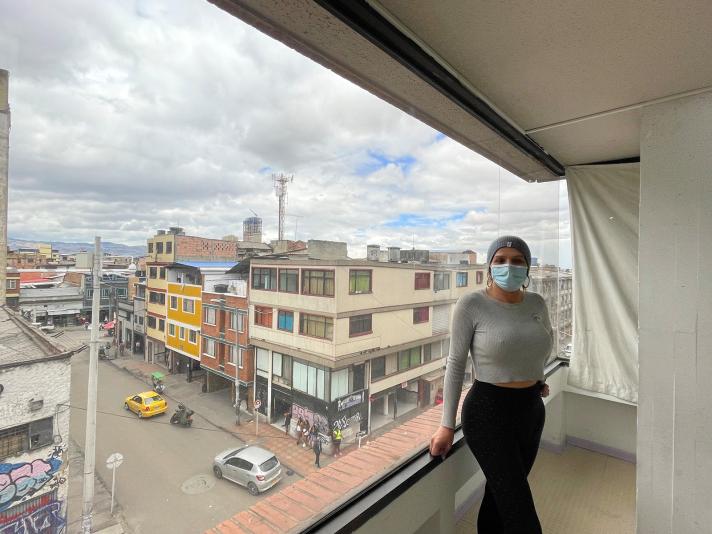 person in front of a big window overlooking the city