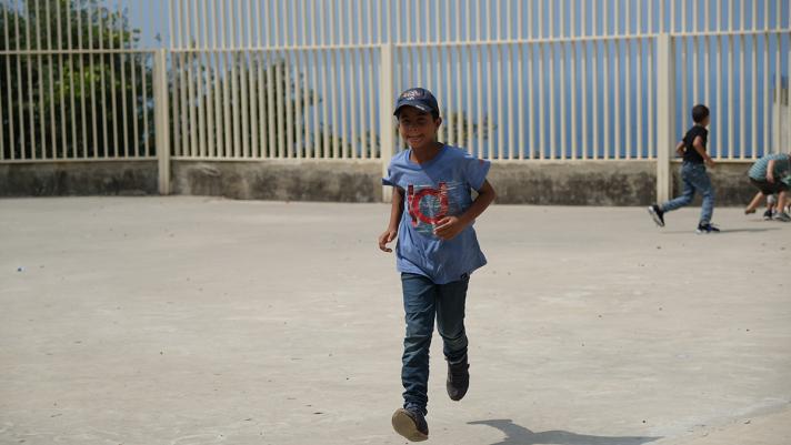 Imad running at the school yard.