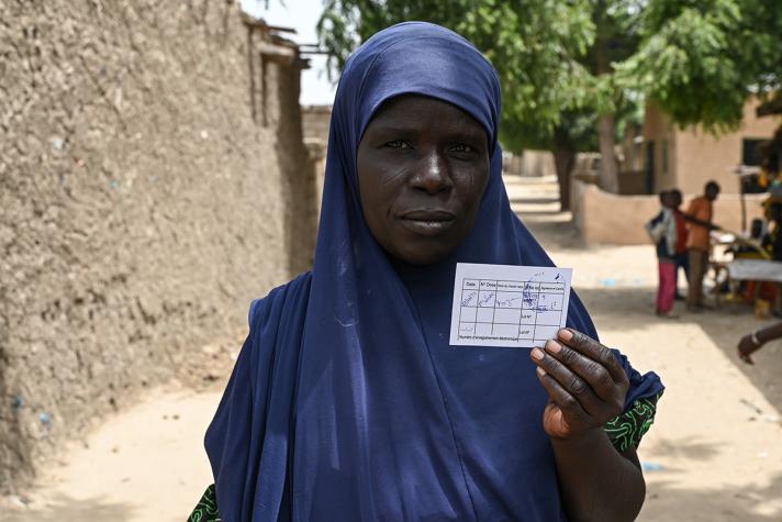 Photo of Chérifa Fassouma Laoulia, showing her vaccination certificate..