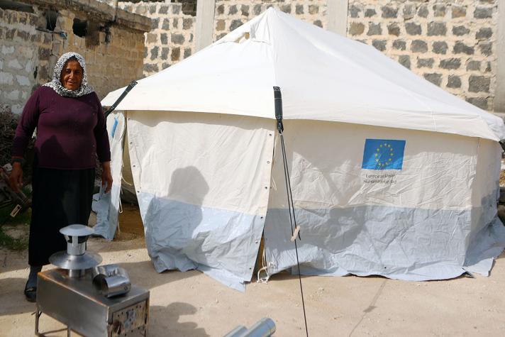 Alifa standing outside in front of a shelter tent