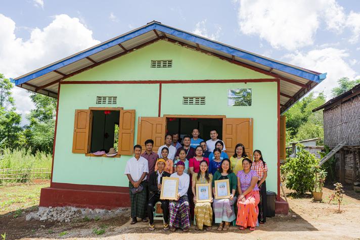 Community members in front of a newly completed community hall