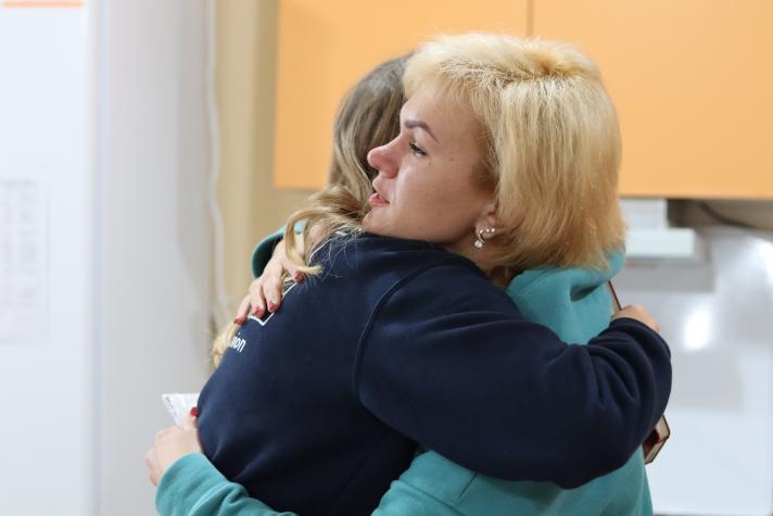 Viktoriia hugging an aid worker.