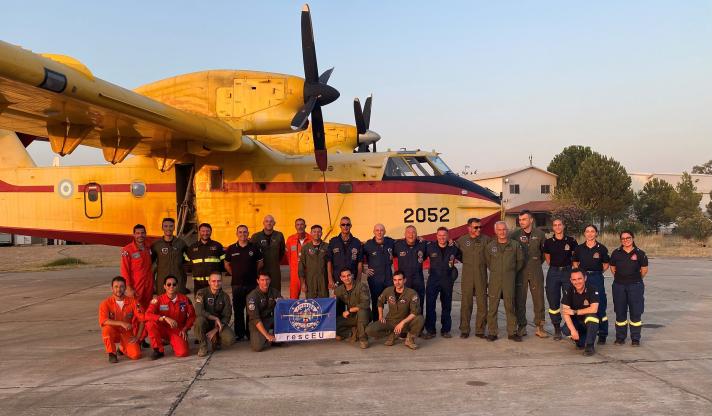 Team of firefighters in front of a canadair