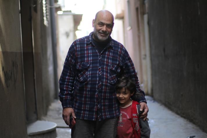 A father and son in front of their Gaza home.