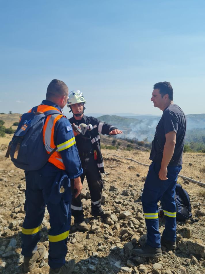 3 firefighters on a hill.