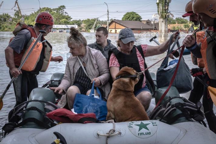 People in a rescue raft in a flooded town.