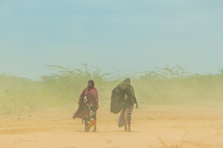 Two Somali refugees walk through the arid pathways of Dadaab camp. 