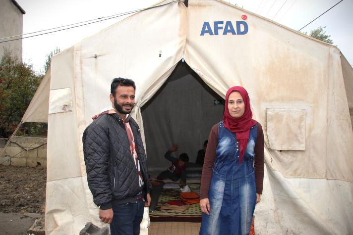 Mohamed and Zari in front of a shelter tent.