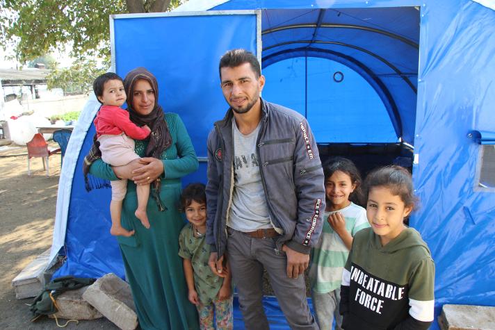 Ahmed and his family in front of a tent