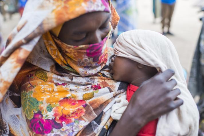 Close-up of Soeba Ibrahim holding her child.
