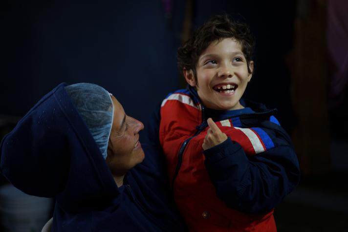 Sara holds her 9-year-old son, who has cerebral palsy.