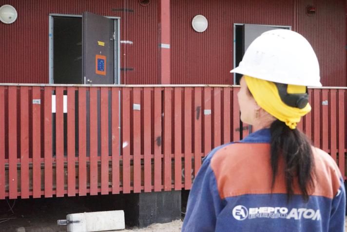 A worker looking at the construction of houses.