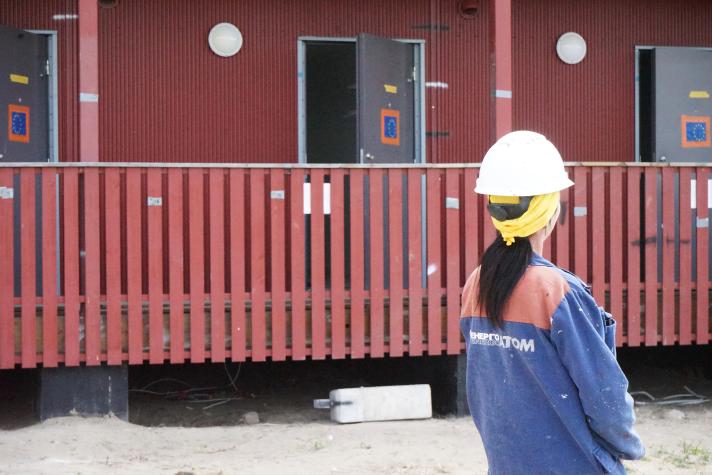 Inna, seen from the back, looking towards the unit that will become her home.