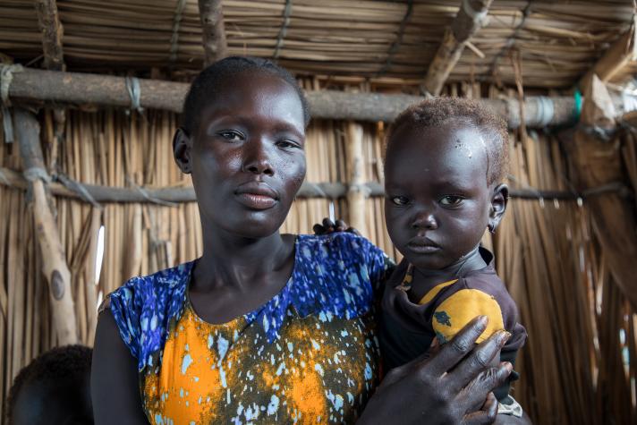 Angelina holding her daughter Nyachar in her arms.