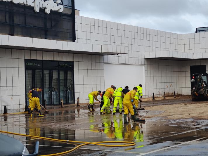 Group of rescue workers cleaning an entrance.