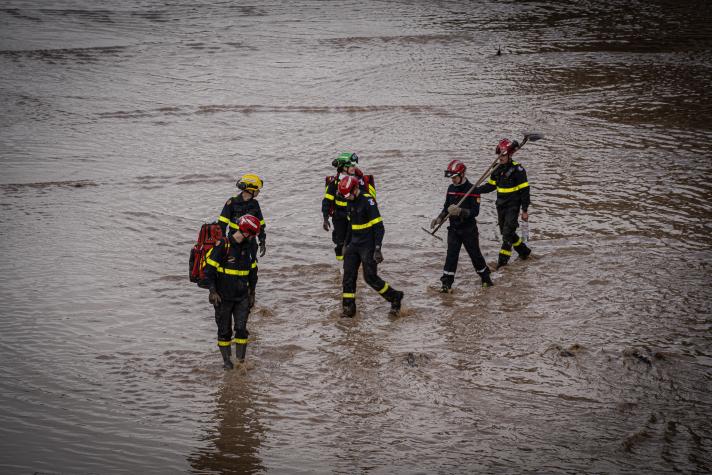 Resceu workers wading through the water.