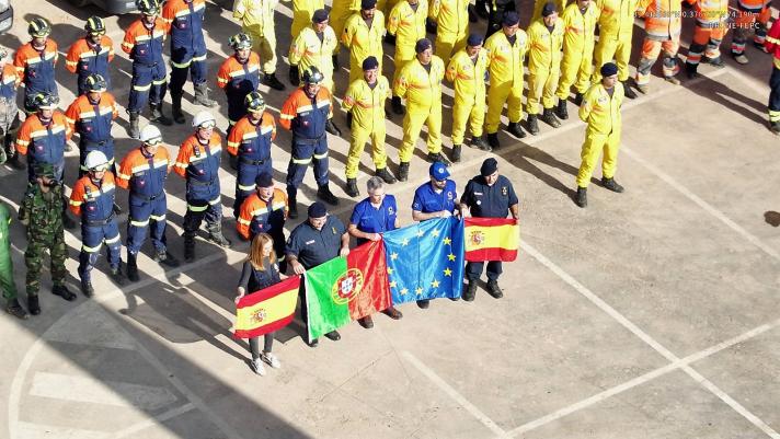 Several groups of resceu workers from different countries posing for a photo.