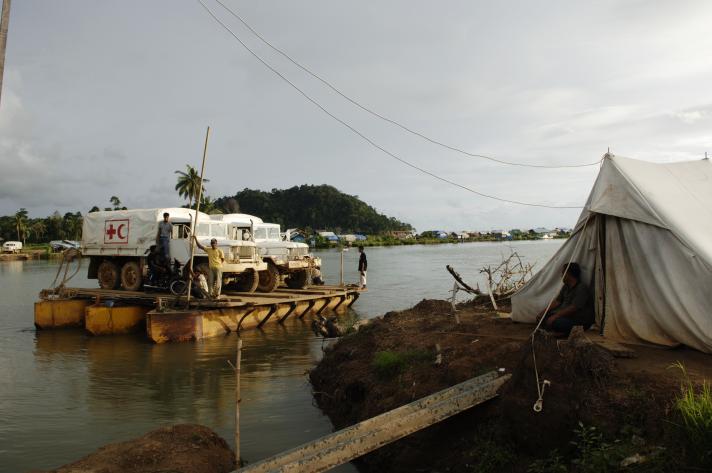 Trucks for the distribution of relief goods are crossing the river on an improvised ferry in Lamno, on the west coast of Aceh, Indonesia.