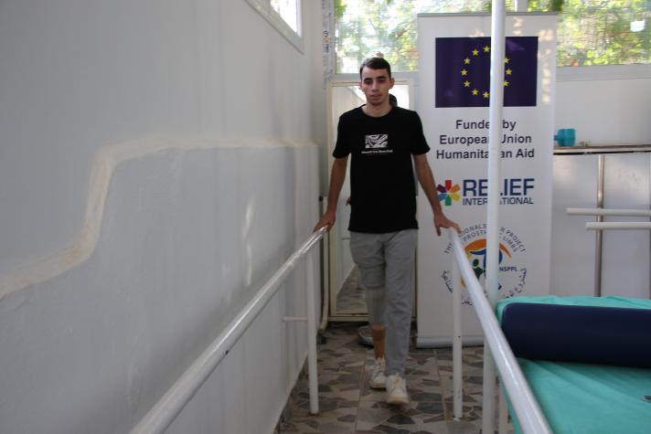 Abdul Hamid walking in a revalidation centre.