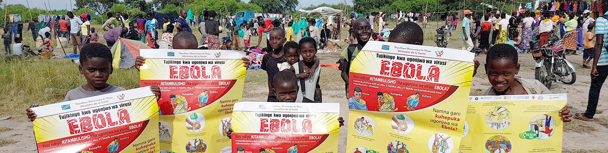 Children holding educative posters about Ebola in their hands
