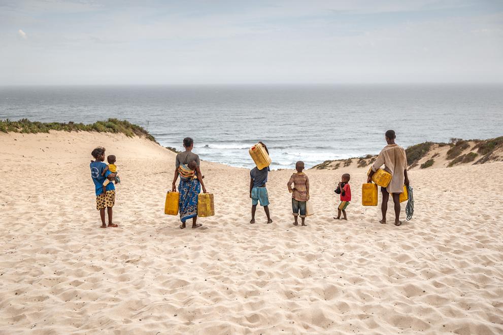 The whole family gets involved in the water collection, walking several kilometres to the nearest well. Everyone has a role to play in the family’s survival.