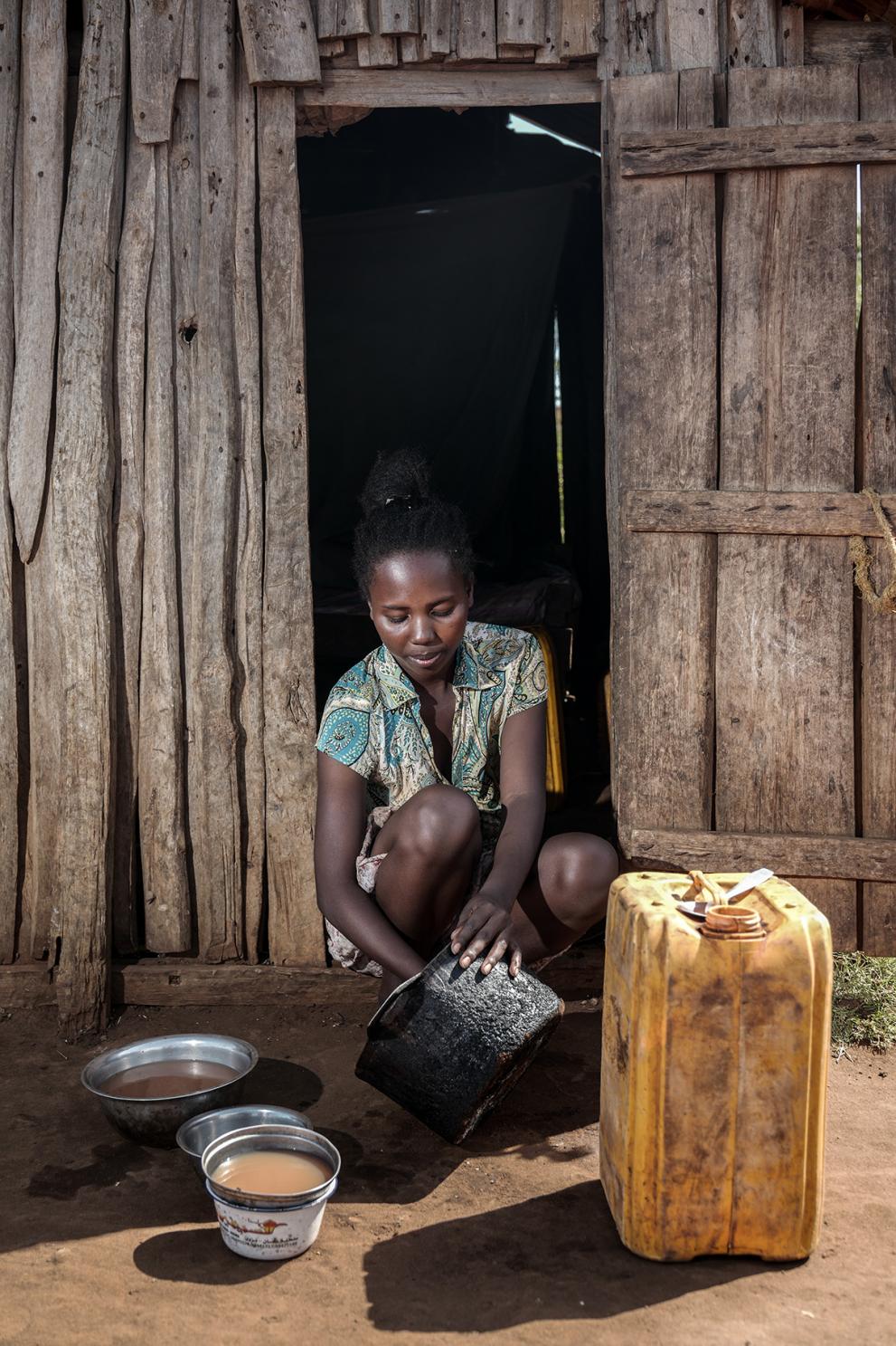 Nearby, Maho’s mother, Toromasy, 20, cleans the pots and plates using the small amount of water she has just collected.