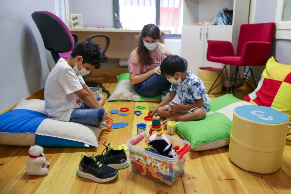 Kids sitting on a floor, playing