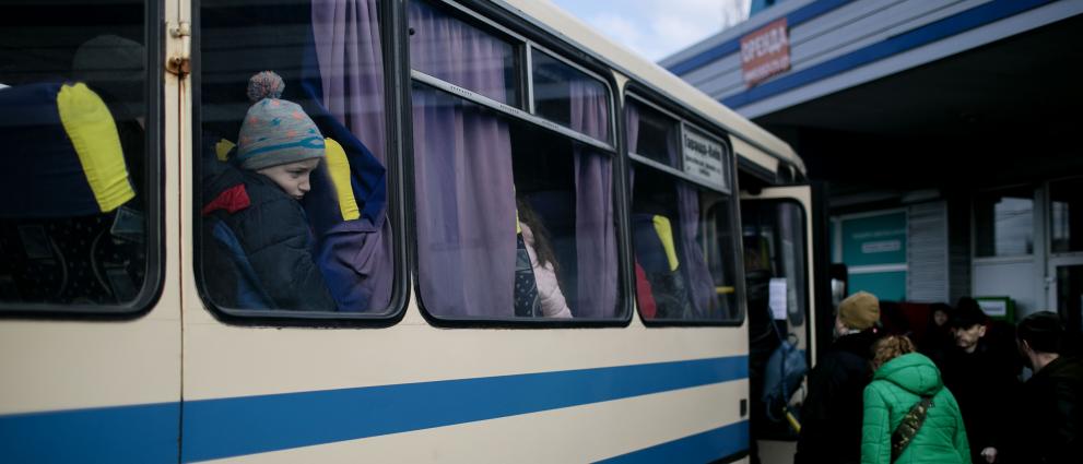People wait in line for the bus, in order to leave Kyiv Ukraine