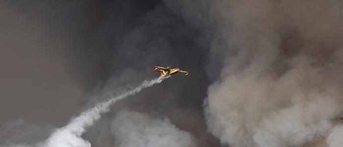 Fire fighter plane in the midsts of smokey clouds