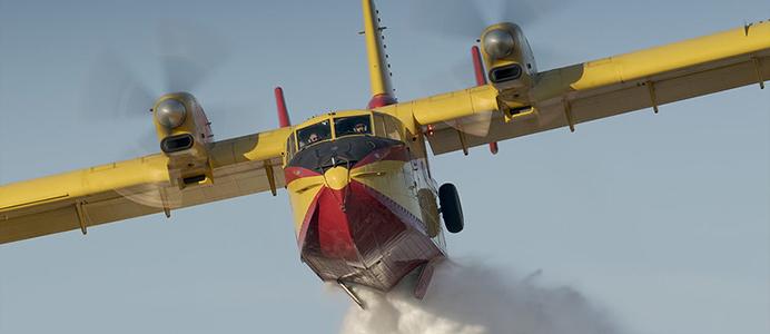 Forest fire plane dropping water