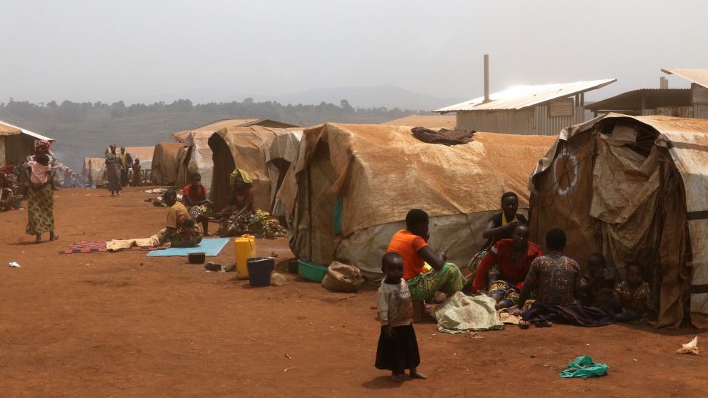 View of tents in a camp with at the forefront a family and child