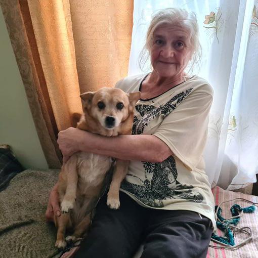 Photo of Olga holding her dog