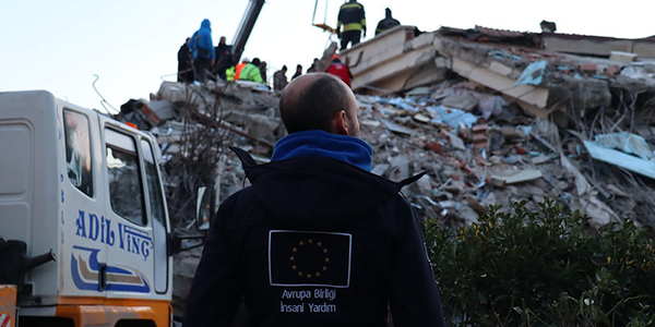 EU civil protection officer standing in front of the rubble caused by the earthquake in Türkiye 