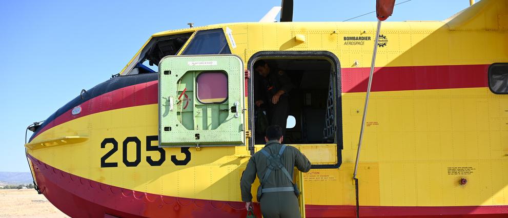 Person stepping into a canadair plane.