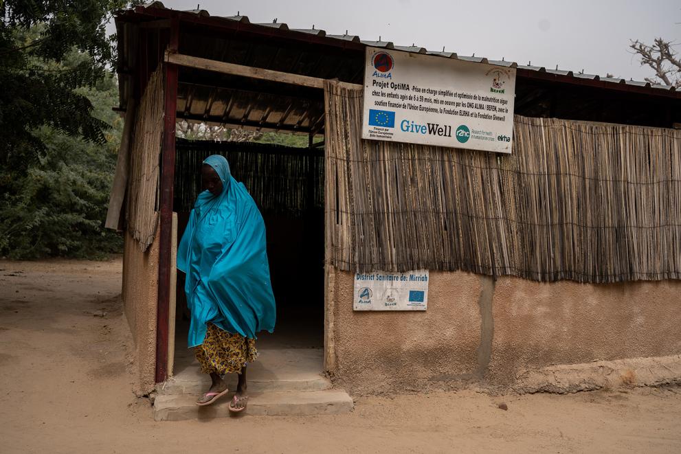 A mother leaves after her child’s malnutrition check up.