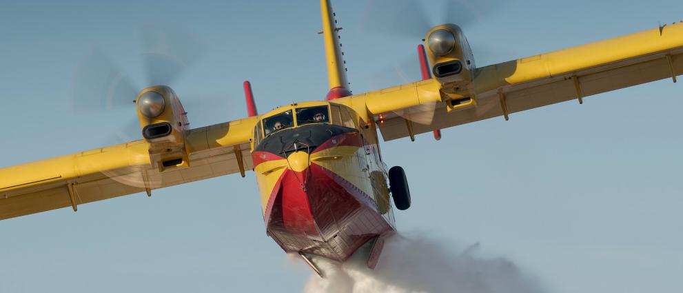 Forest fire plane dropping water