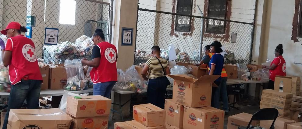 Aid workers filling boxes with emergency goods.